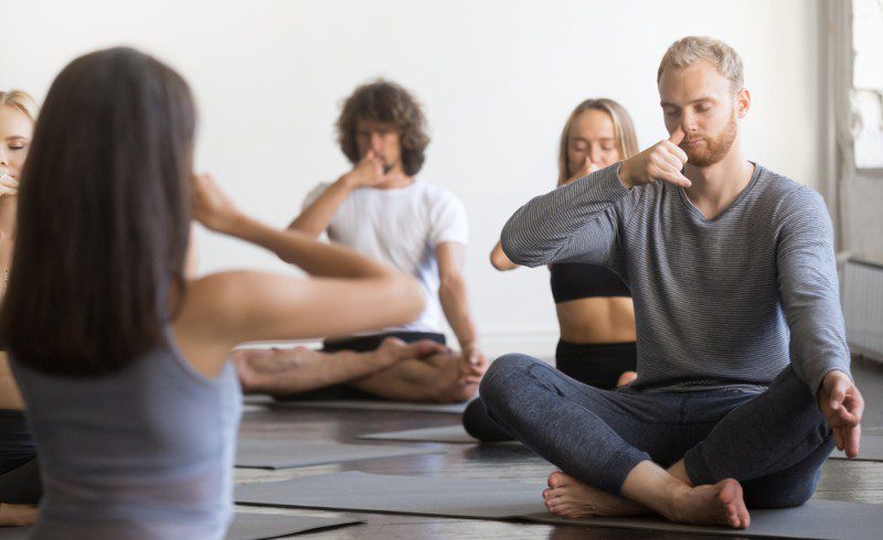 A group of People do yoga For Best Breathing