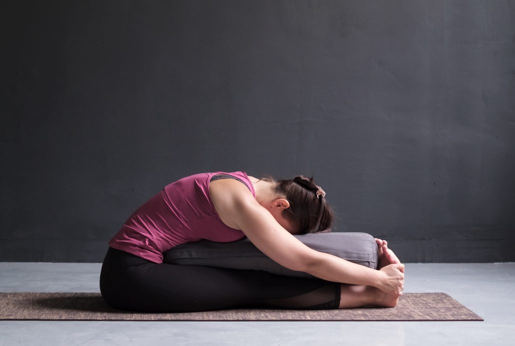 a women practicing Forward Bend in Kundalini Yoga