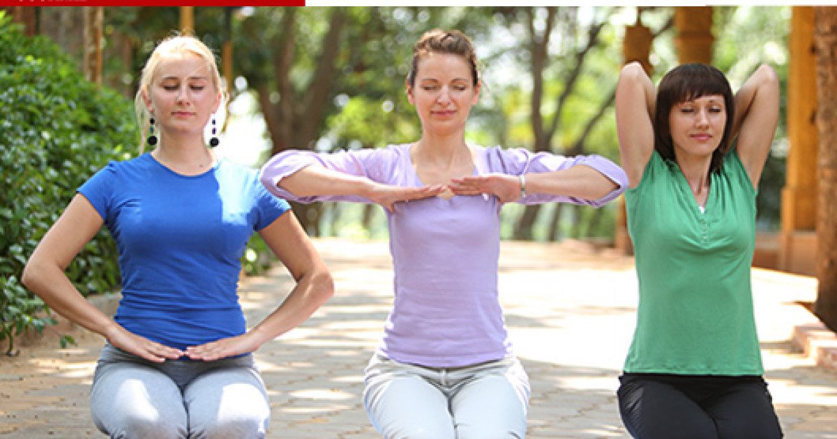 three women do yoga